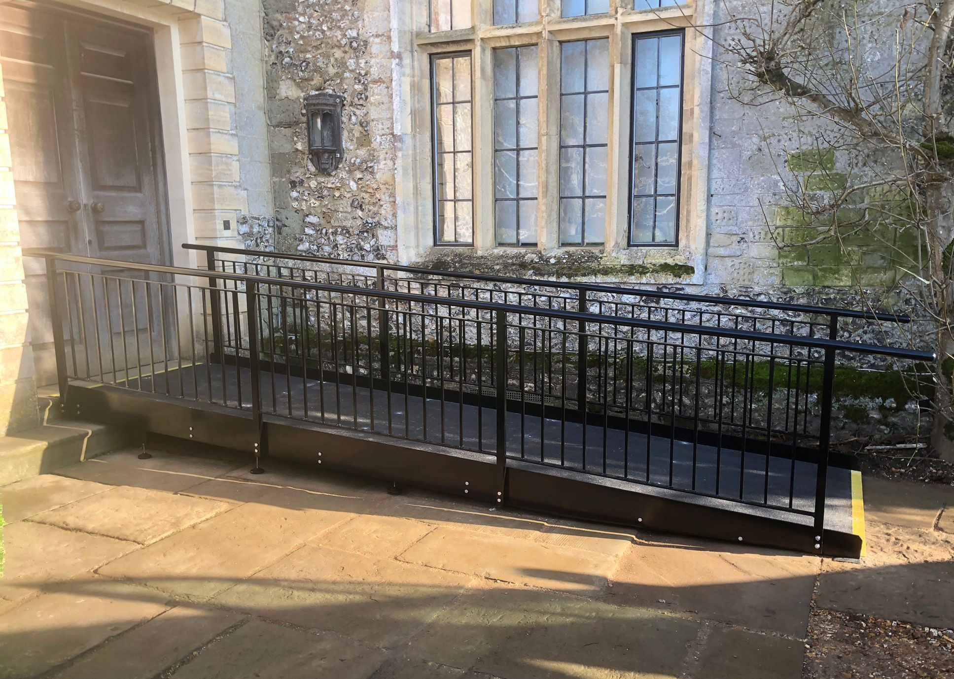 Accessibility ramp with handrails